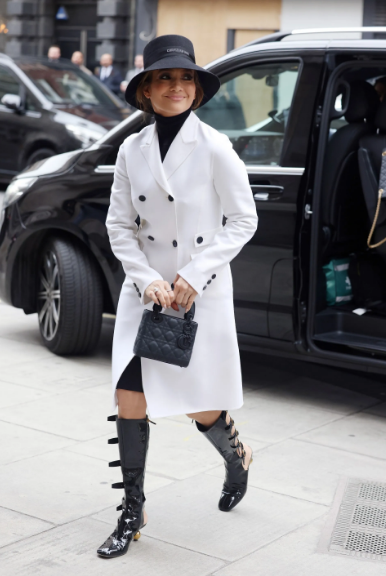 Jennifer Lopez in Dior with a white coat and patent leather "gladiator" boots updates women's look