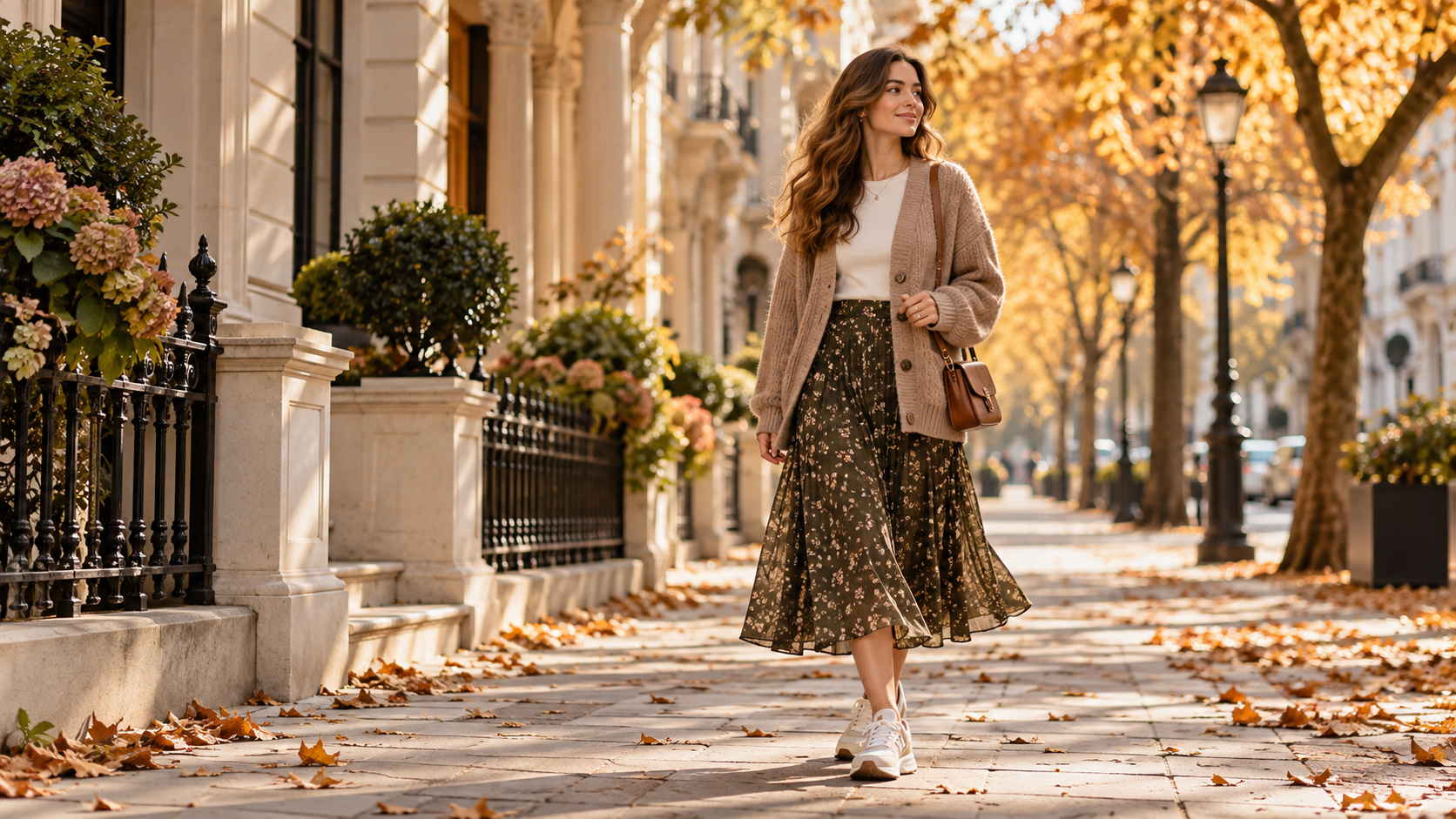Printed midi skirt with white T-shirt, knitted cardigan, trainers and brown women's bag